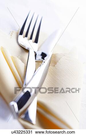 Close up of fork and knife lies on cloth View Large Photo Image Stock Image - Close up of fork and knife lies on cloth. Fotosearch