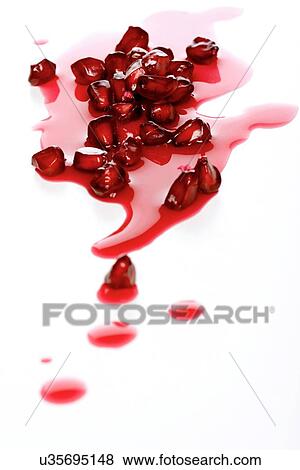 Stock Photo - Close-up of pomegranate seeds on white background. Fotosearch