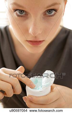 Close-up of woman holding facial cleanser View Large Photo Image Picture - Close-up of woman holding facial cleanser. Fotosearch