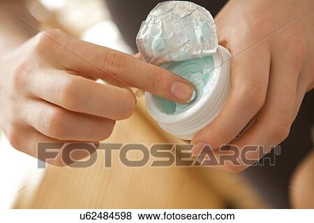 Stock Photo - Close-up of woman holding facial cleanser. Fotosearch