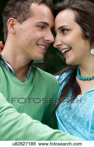 Close-up of young couple looking at each other View Large Photo Image Stock Photo - Close-up of young couple looking at each other. Fotosearch
