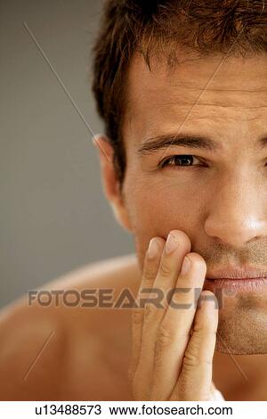 Close-up of young man applying shaving cream View Large Photo Image Stock Image - Close-up of young man applying shaving cream. Fotosearch