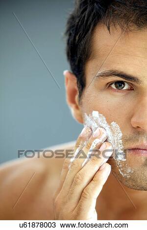 Close-up of young man applying shaving cream View Large Photo Image Stock Image - Close-up of young man applying shaving cream. Fotosearch