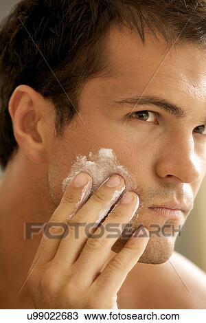 Close-up of young man applying shaving cream View Large Photo Image Stock Image - Close-up of young man applying shaving cream. Fotosearch