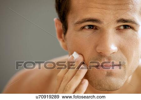 Close-up of young man applying shaving cream View Large Photo Image Stock Photo - Close-up of young man applying shaving cream. Fotosearch