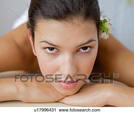 Close-up of young woman relaxing on massage table View Large Photo Image Stock Image - Close-up of young woman relaxing on massage table. Fotosearch