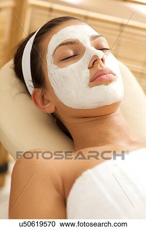 Close-up of young woman wearing facial mask View Large Photo Image Stock Image - Close-up of young woman wearing facial mask. Fotosearch
