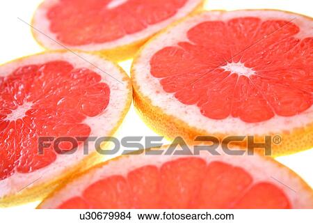 Closeup of sliced grapefruit on white background View Large Photo Image Picture - Closeup of sliced grapefruit on white background. Fotosearch
