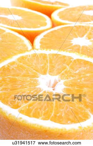 Stock Photo - Closeup of sliced oranges - studio shot. Fotosearch
