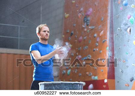 Confident man dusting powder by climbing wall in crossfit gym View Large Photo Image Stock Photo - Confident man dusting powder by climbing wall in crossfit gym. Fotosearch
