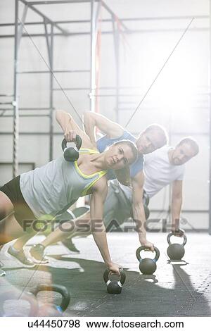 Confident people exercising in crossfit gym View Large Photo Image Stock Photo - Confident people exercising in crossfit gym. Fotosearch