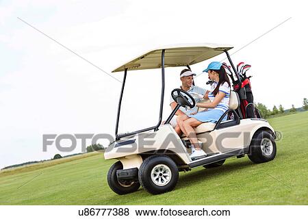 Couple looking at each other while sitting in golf cart against clear sky View Large Photo Image Stock Photo - Couple looking at each other while sitting in golf cart against clear sky. Fotosearch