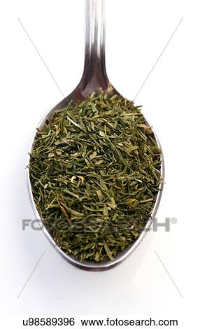 Stock Photograph - Dried rosemary on spoon - studio shot. Fotosearch