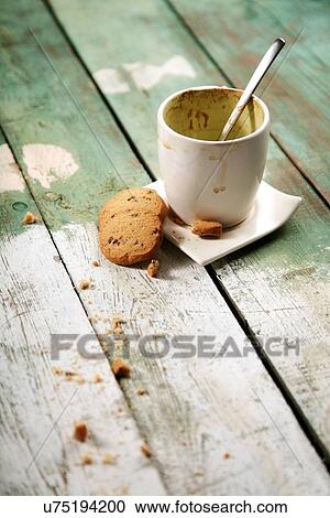 Stock Image - Empty coffee cup on wooden table. Fotosearch