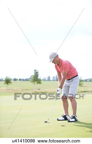 Full-length of middle-aged man playing golf at course View Large Photo Image Stock Photo - Full-length of middle-aged man playing golf at course. Fotosearch