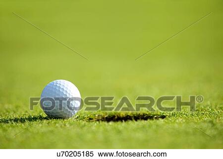 Golf ball near hole View Large Photo Image Stock Photography - Golf ball near hole. Fotosearch