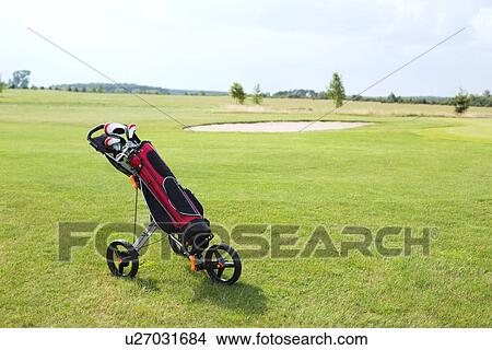 Golf club bag on pushcart at golf course against sky View Large Photo Image Picture - Golf club bag on pushcart at golf course against sky. Fotosearch