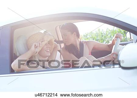 Happy female friends enjoying road trip View Large Photo Image Picture - Happy female friends enjoying road trip. Fotosearch