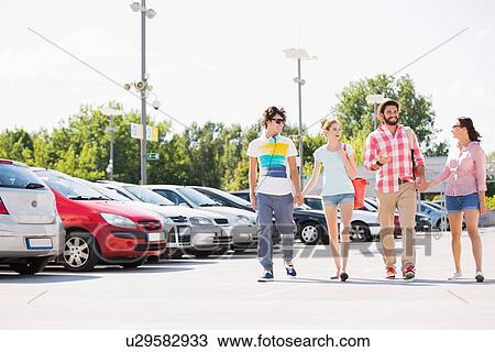 Happy friends walking on city street View Large Photo Image Stock Image - Happy friends walking on city street. Fotosearch