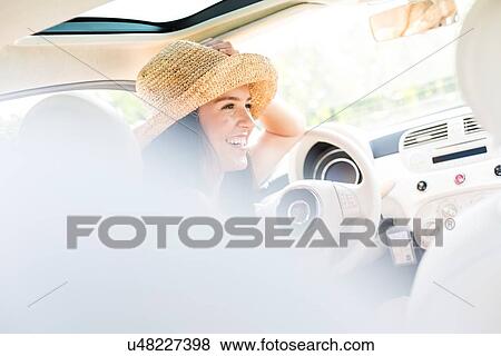 Happy woman sitting in car View Large Photo Image Stock Photo - Happy woman sitting in car. Fotosearch