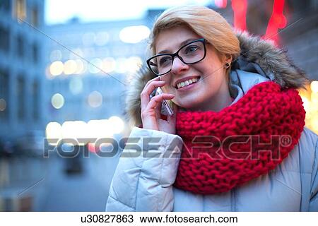 Happy woman using cell phone outdoors during winter View Large Photo Image Stock Image - Happy woman using cell phone outdoors during winter. Fotosearch