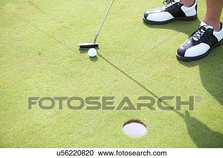 Stock Image - High angle view of man playing golf. Fotosearch