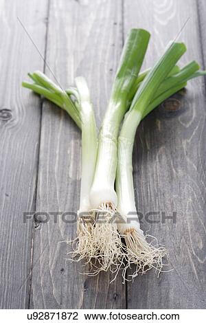 Leeks on wooden table - studio shot View Large Photo Image Stock Image - Leeks on wooden table - studio shot. Fotosearch