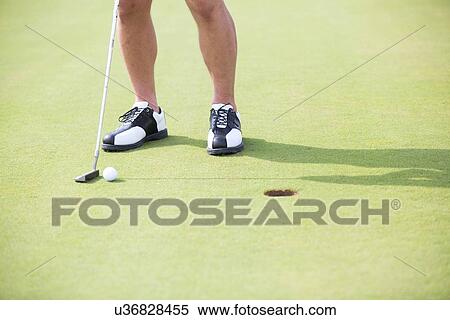 Low section of man with golf club and ball View Large Photo Image Stock Photography - Low section of man with golf club and ball. Fotosearch