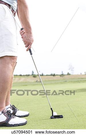 Low section of mid-adult man playing golf against clear sky View Large Photo Image Stock Image - Low section of mid-adult man playing golf against clear sky. Fotosearch