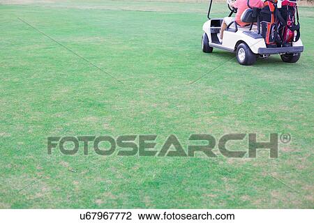 Low section of middle-aged man driving golf cart View Large Photo Image Stock Image - Low section of middle-aged man driving golf cart. Fotosearch