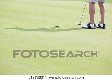Low section of middle-aged man playing golf View Large Photo Image Stock Image - Low section of middle-aged man playing golf. Fotosearch