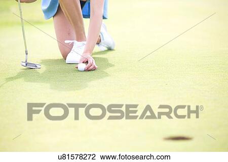 Low section of woman placing ball at golf course View Large Photo Image Stock Image - Low section of woman placing ball at golf course. Fotosearch