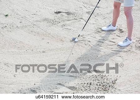 Stock Image - Low section of woman playing at golf course. Fotosearch