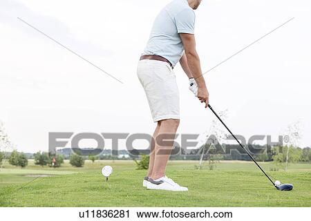Low section side view of man playing golf against clear sky View Large Photo Image Stock Image - Low section side view of man playing golf against clear sky. Fotosearch