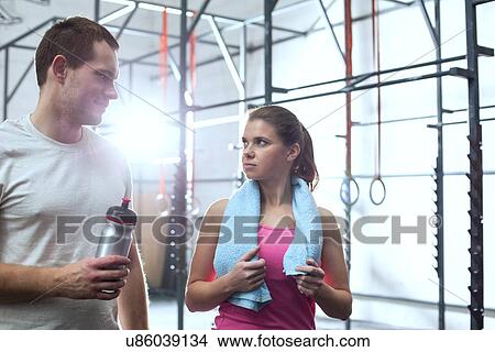 Man and woman looking at each other in crossfit gym View Large Photo Image Picture - Man and woman looking at each other in crossfit gym. Fotosearch
