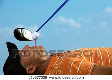 Man balancing golf ball on tee in his mouth View Large Photo Image Stock Photo - Man balancing golf ball on tee in his mouth. Fotosearch