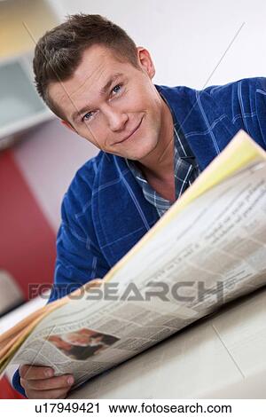 Stock Image - Man reading newspape. Fotosearch