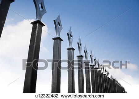 Metal fence over blue sky View Large Photo Image Stock Image - Metal fence over blue sky. Fotosearch
