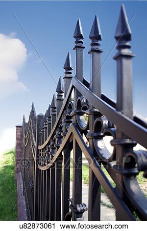 Stock Image - Metal fence over blue sky. Fotosearch