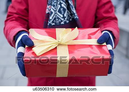 Midsection of man holding gift box winter View Large Photo Image Stock Image - Midsection of man holding gift box winter. Fotosearch