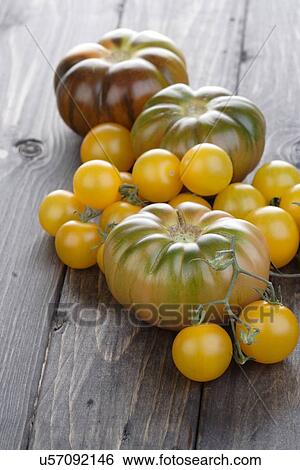 Stock Photograph - Mix tomatoes on wooden table. Fotosearch