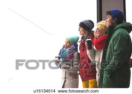 Multiethnic friends looking away against clear sky during winter View Large Photo Image Picture - Multiethnic friends looking away against clear sky during winter. Fotosearch