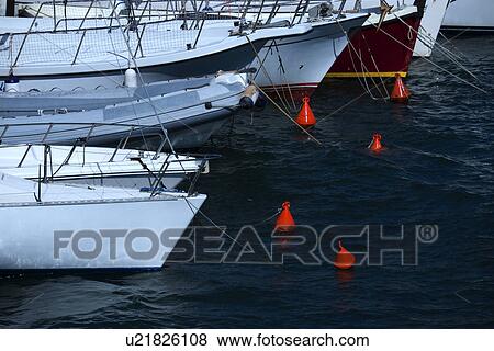 Multiple boats tied to buoys at the bay View Large Photo Image Stock Photo - Multiple boats tied to buoys at the bay. Fotosearch