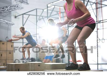 People doing box jump exercise in crossfit gym View Large Photo Image Stock Photograph - People doing box jump exercise in crossfit gym. Fotosearch