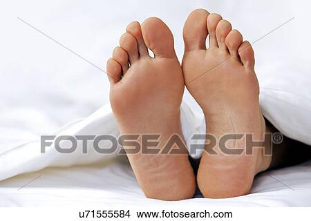 Person's foot in bed, close-up View Large Photo Image Picture - Person's foot in bed, close-up. Fotosearch