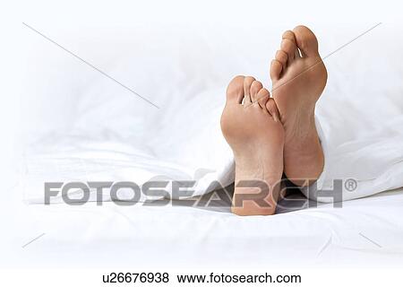 Person's foot in bed View Large Photo Image Stock Photo - Person's foot in bed. Fotosearch