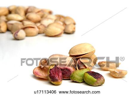 Stock Photograph - Pistachios on white background - studio shot. Fotosearch