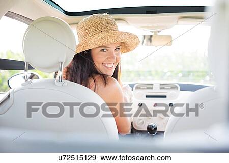 Stock Photo - Portrait of beautiful woman driving car. Fotosearch