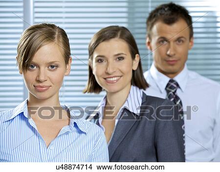 Portrait of businessman and businesswomen smiling in office View Large Photo Image Picture - Portrait of businessman and businesswomen smiling in office. Fotosearch
