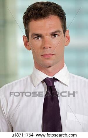Picture - Portrait of businessman at office. Fotosearch
